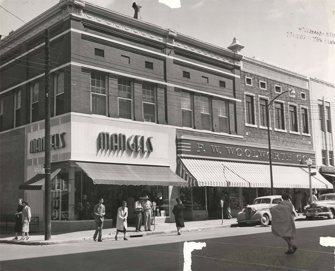 Both the appearance and use of this building have changed over time, housing both a  grocery store and various clothing stores. During the 1950s, the building’s right bay was part of the F. W. Woolworth store. Subsequent owners restored the building to its current appearance.